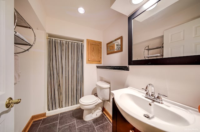 bathroom featuring tile patterned floors, curtained shower, vanity, and toilet