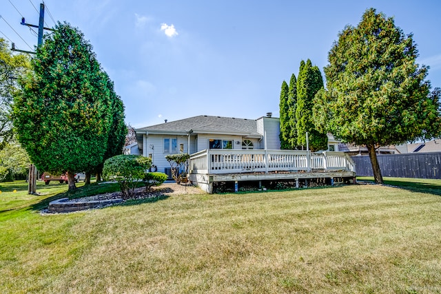 back of house featuring a yard and a deck