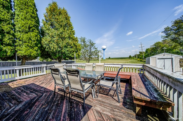 wooden deck featuring a storage unit