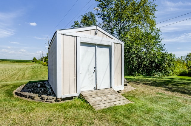 view of outbuilding featuring a yard