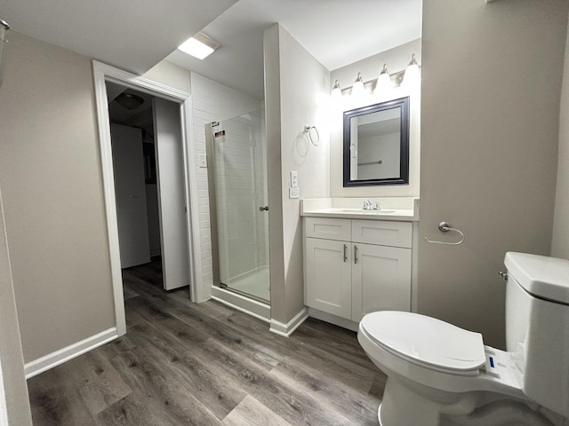 bathroom featuring hardwood / wood-style flooring, vanity, toilet, and an enclosed shower