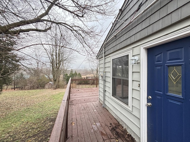 wooden terrace featuring a shed