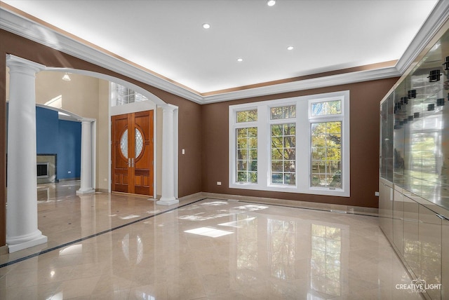 foyer entrance featuring decorative columns and crown molding