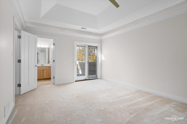 unfurnished bedroom with access to outside, a raised ceiling, ensuite bath, ceiling fan, and light colored carpet