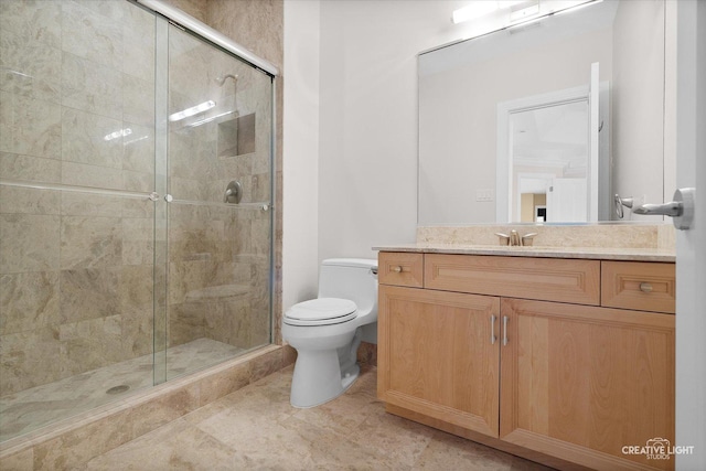 bathroom featuring vanity, toilet, and a shower with shower door