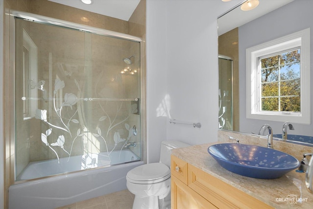 full bathroom with tile patterned floors, vanity, toilet, and shower / bath combination with glass door