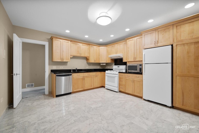 kitchen featuring sink, stainless steel appliances, and light brown cabinetry