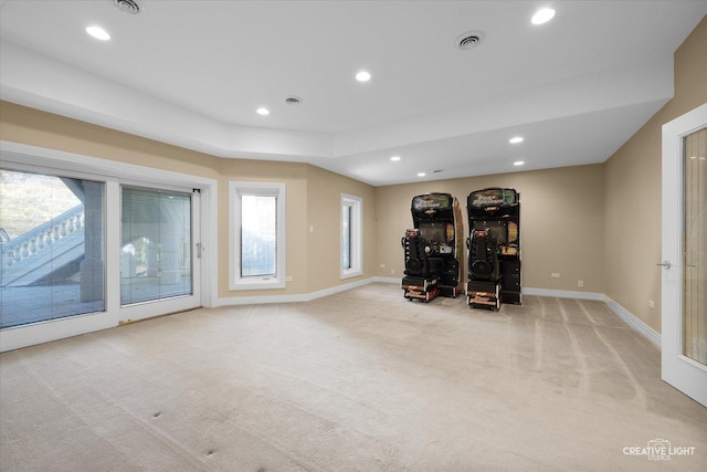 workout area with plenty of natural light and light colored carpet