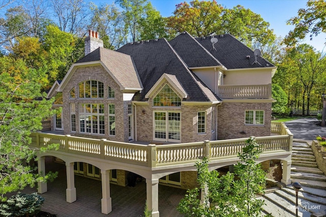 back of property featuring a wooden deck