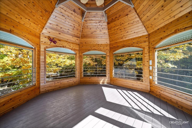 unfurnished sunroom with vaulted ceiling with beams, plenty of natural light, and wood ceiling