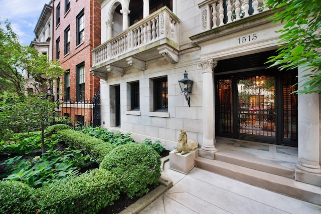 view of exterior entry with a balcony