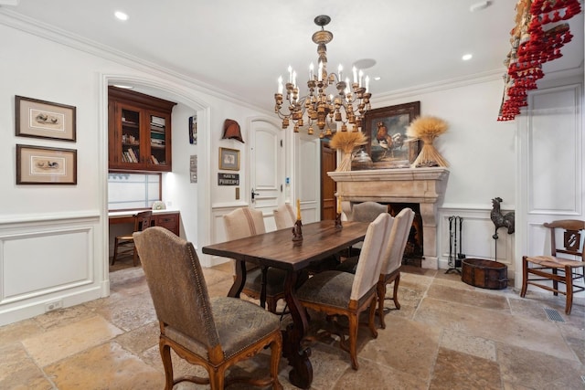 dining room with ornamental molding and an inviting chandelier