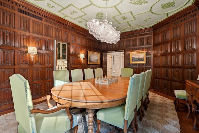 dining space with a notable chandelier and wood walls