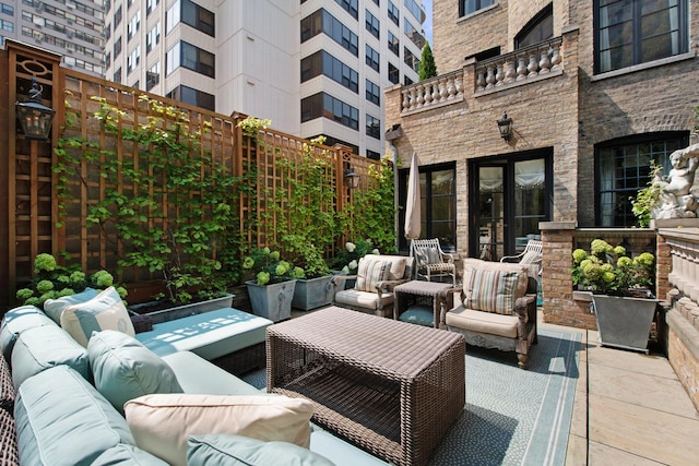 view of patio with outdoor lounge area and a balcony