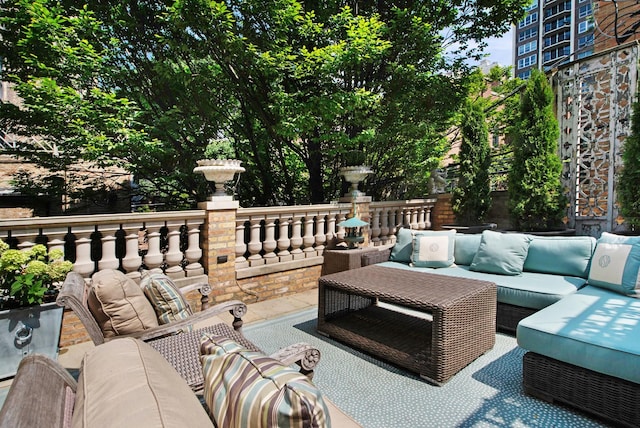 view of patio featuring an outdoor hangout area and a balcony