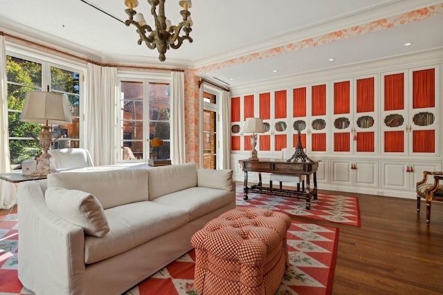 interior space featuring an inviting chandelier, dark wood-type flooring, and ornamental molding