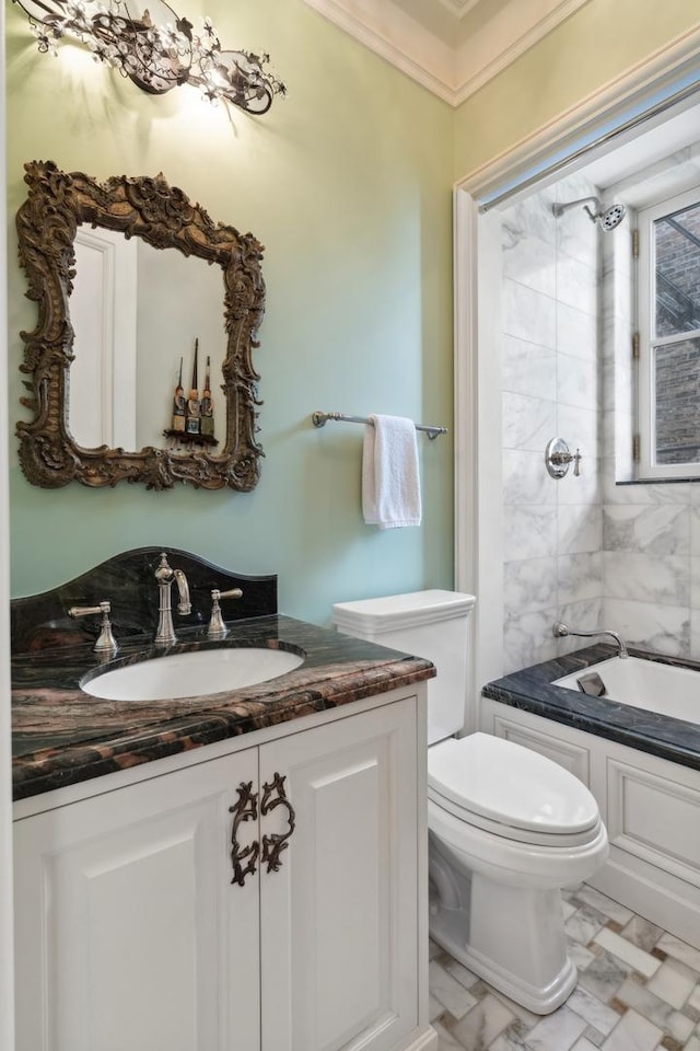 bathroom featuring vanity, a tub to relax in, toilet, and ornamental molding