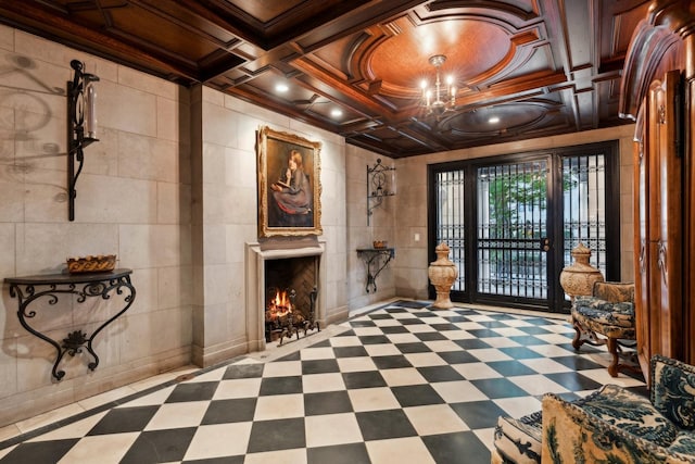 foyer featuring wooden ceiling, coffered ceiling, ornamental molding, tile walls, and beam ceiling