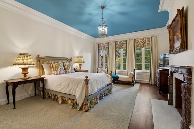 bedroom featuring crown molding, dark wood-type flooring, and a chandelier