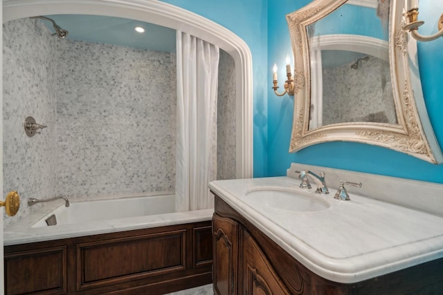 bathroom with a washtub and vanity