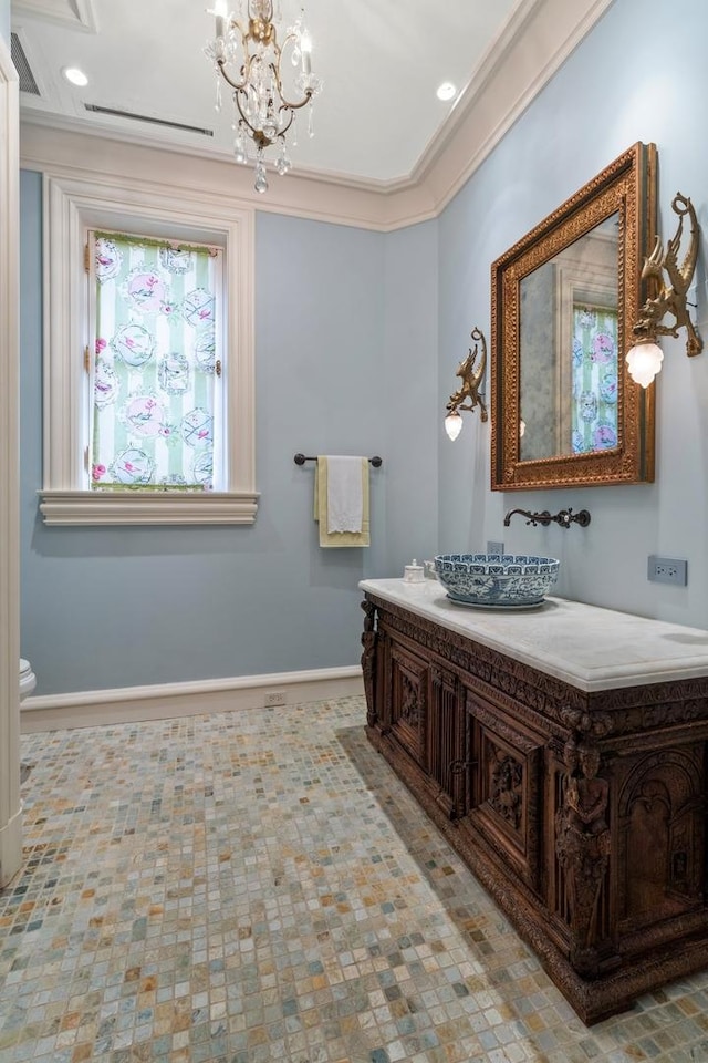 bathroom with vanity, toilet, an inviting chandelier, and ornamental molding