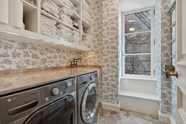 laundry area with independent washer and dryer and sink