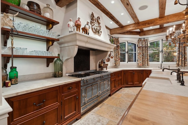 kitchen with beam ceiling, stainless steel gas cooktop, and sink