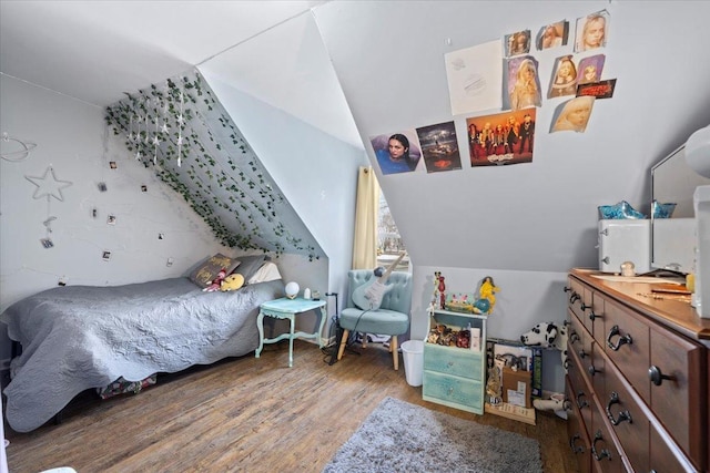 bedroom with lofted ceiling and hardwood / wood-style flooring