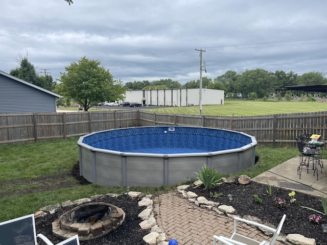 view of swimming pool with a fire pit