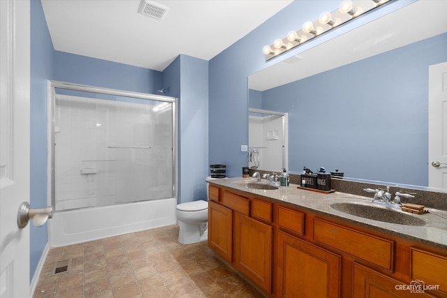 full bathroom featuring toilet, vanity, and combined bath / shower with glass door