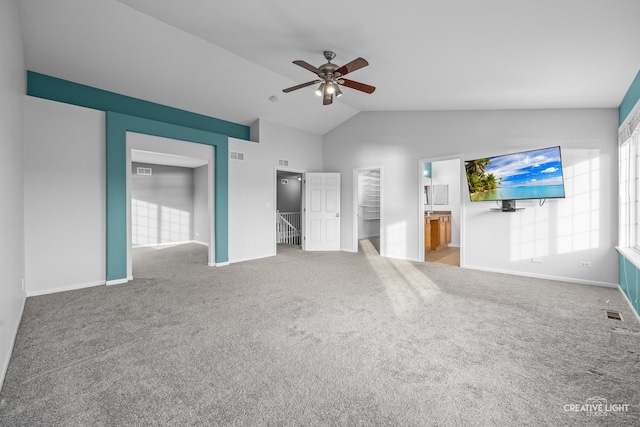 unfurnished living room with carpet floors, vaulted ceiling, and ceiling fan