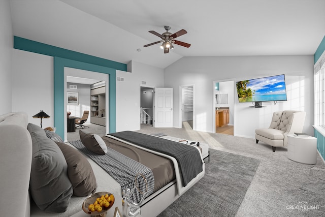 bedroom featuring ensuite bath, ceiling fan, light colored carpet, and lofted ceiling