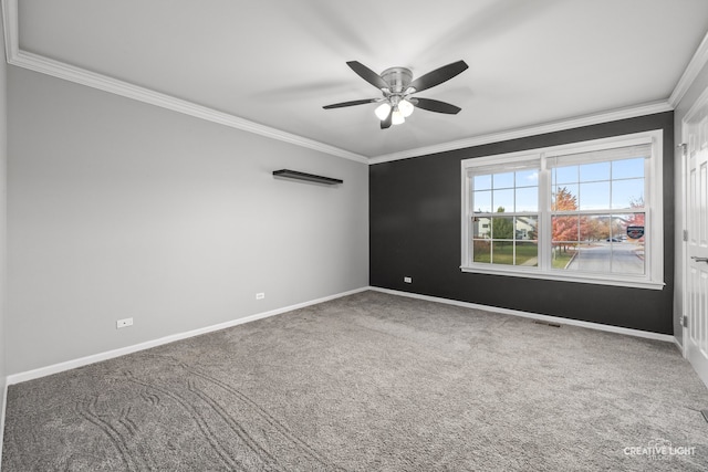 spare room featuring carpet, ceiling fan, and ornamental molding