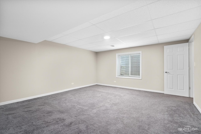 carpeted spare room with a paneled ceiling