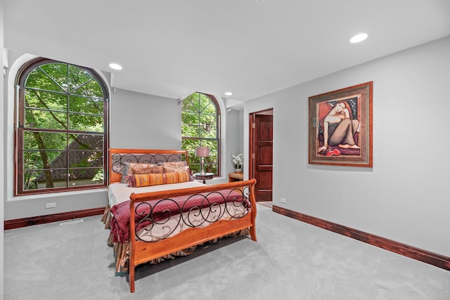 carpeted bedroom featuring recessed lighting and baseboards