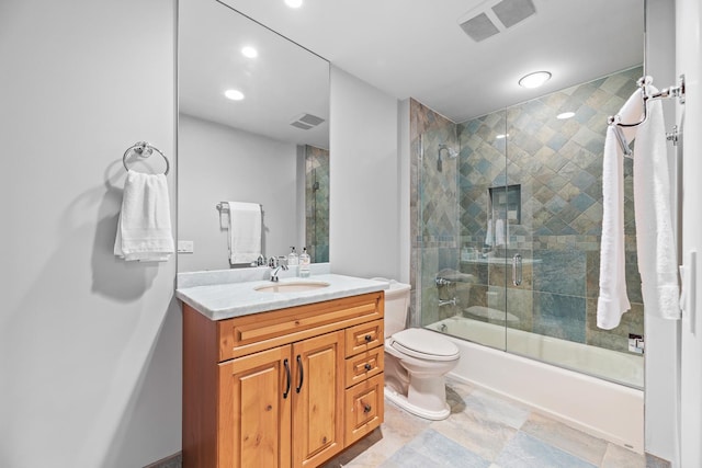 bathroom featuring vanity, toilet, visible vents, and shower / bath combination with glass door