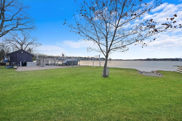 view of yard with a water view and a storage unit