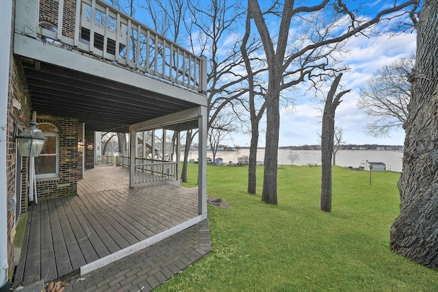 view of yard with a deck with water view