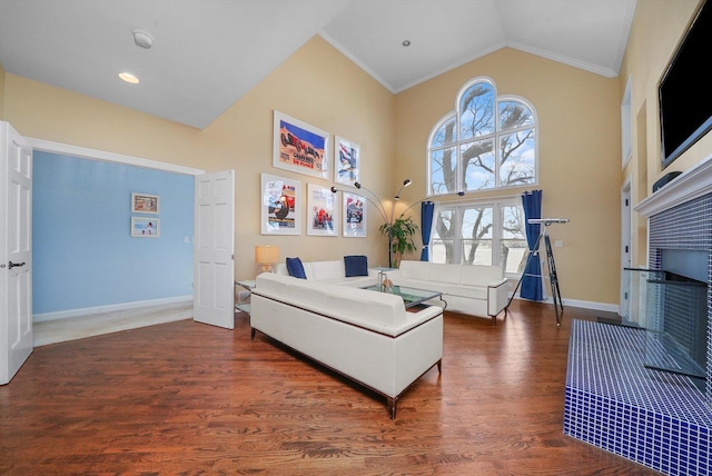 living room with crown molding, high vaulted ceiling, and dark hardwood / wood-style floors