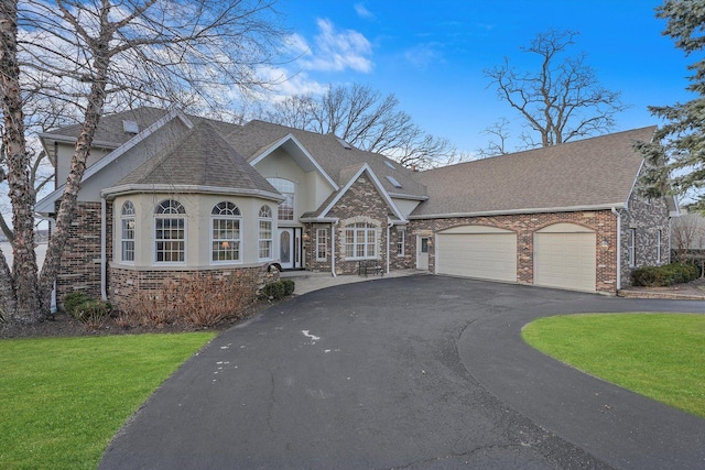 view of front of property with a garage and a front lawn