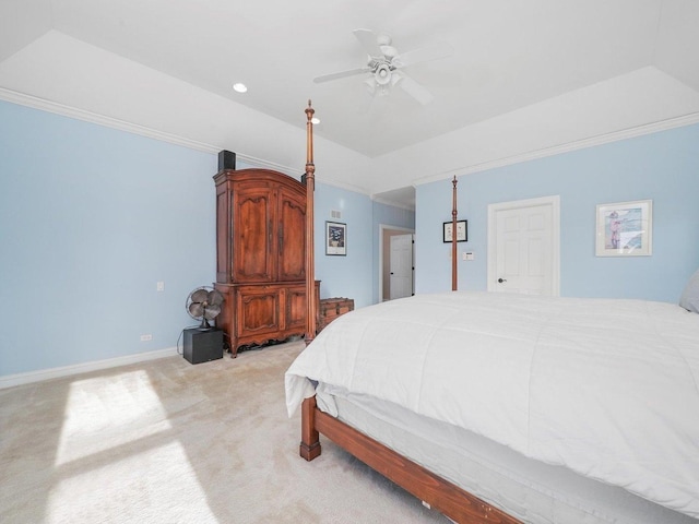 carpeted bedroom featuring ceiling fan, ornamental molding, and a tray ceiling