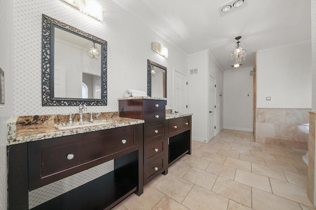 bathroom featuring tile patterned flooring, vanity, and crown molding