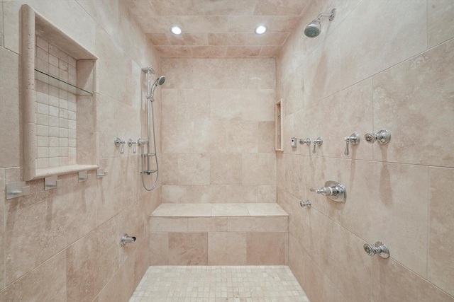 bathroom with a tile shower