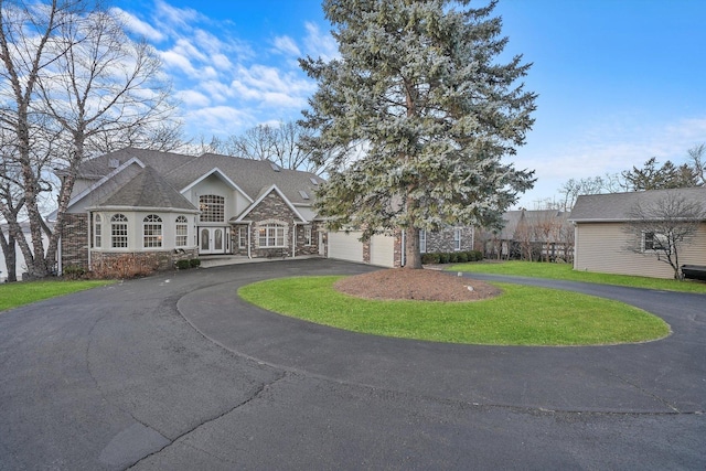 view of front of house with a front yard and a garage