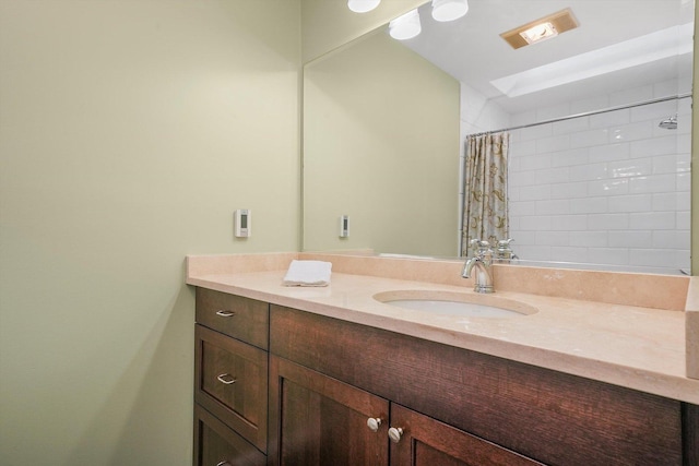 bathroom featuring curtained shower and vanity