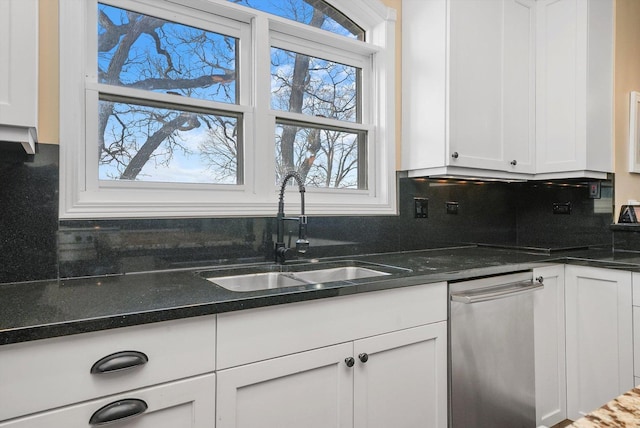 kitchen with tasteful backsplash, white cabinetry, and sink