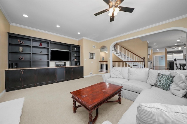 living room with ceiling fan, light colored carpet, and crown molding