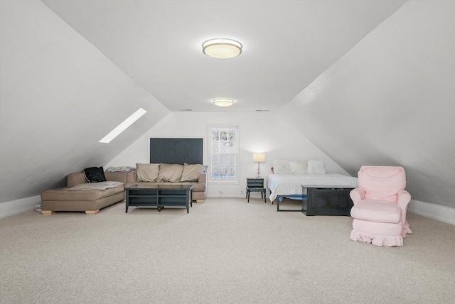 interior space with carpet floors and vaulted ceiling with skylight