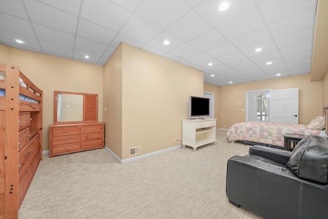 bedroom featuring a paneled ceiling and light colored carpet