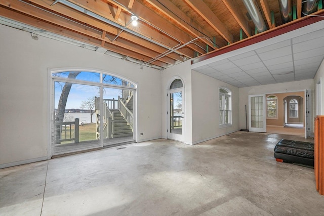 unfurnished living room featuring concrete floors